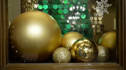 Close-up New Year's and Christmas decorations in window. Gold balls 스톡 동영상 69990153