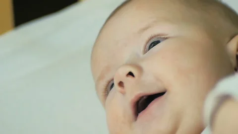 Close-up of a newborn babe smiling looking at camera in slow motion. Stock Footage 98581910