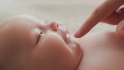 Close Up of Newborn Baby Face Being Gently Touched by Loving Parent Hand Stock Footage 315862453