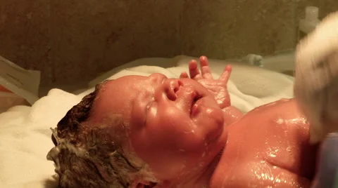 Close up newborn baby getting first bath Stock Footage 51397456