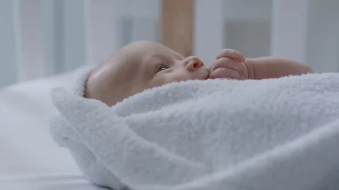Close-up, newborn baby lying in bed on towel, after bath Stock Footage 306006549