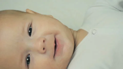 Close-up of a newborn boy looking at camera in his bed in slow motion. Stock Footage 98582742