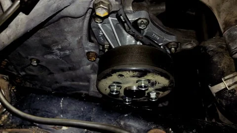 Close-up of a newly installed car engine water pump and pulley assembly Stock Footage 340414708