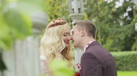Close-up. Newlyweds are looking at each other with love and kissing. Stock Footage 68446711