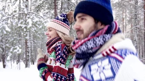 Close-up of nice young couple running in the forest on a winter morning Stock-Footage 71258226
