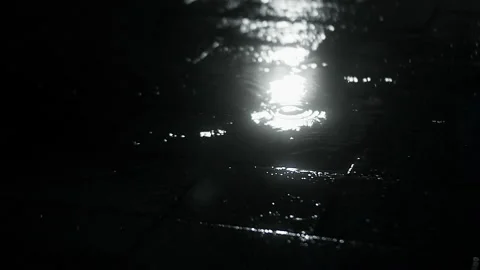 Close-up at night, drops of summer or autumn rain fall on the asphalt in the Vidéo 223013527