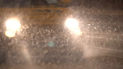 Close-up of a night traffic moving in a snowfall. Headlights in Winter storm. Stock-Footage 83539566