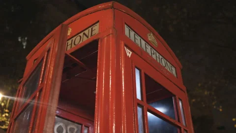 A close up night view of a red telephone booth with the closing door. Stock Footage 167655236