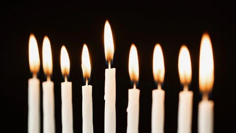 Close up of nine lit candles burning for the Jewish holiday of Hanukkah, Stock Footage 99757732