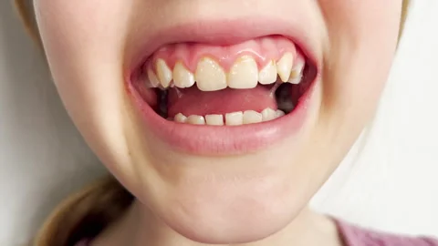 Close up of a nine years old girl sticking out her tongue playfully. The image Stock Footage 310191553