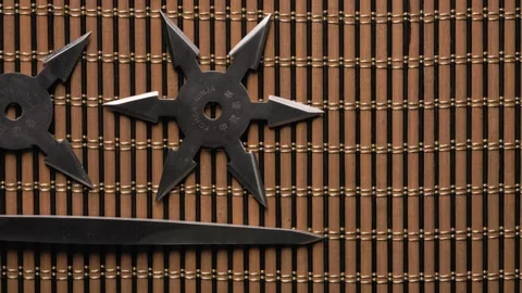 Close-up of Ninja Star with Throwing Spikes on Wooden Background. 库存影片 312666188