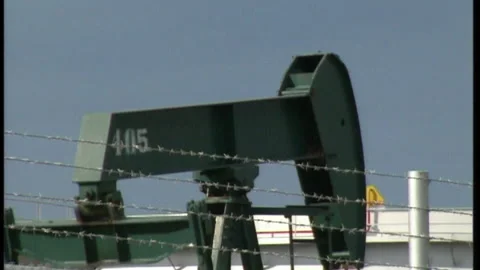 Close-up nodding donkey (pumpjack) near Seria oil terminal, Brunei Stock Footage 134353350