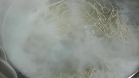Close-Up of Noodles Boiling in Hot Bubbling Water Stock Footage 333523920