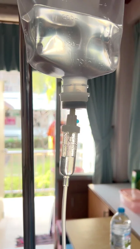 Close Up Normal Saline IV Drip Infusion for Patient Hydration and Medical Care Stock Footage 328386911