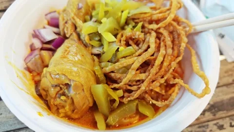 Close-up of Northern Thai coconut curry noodle soup or Khao Soi Gai. 스톡 동영상 339780863