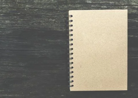 Close note book on wooden background Stock Photos