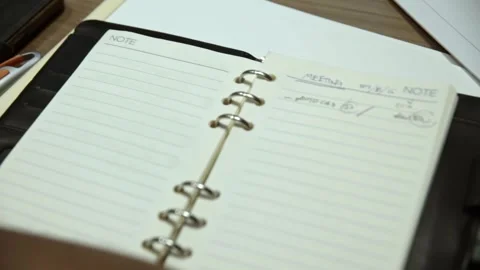 Close up of notebook on desk at office with remarks on it Stock Footage 280867043