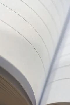 A close-up of notebook pages forming a soft, wavy pattern. Stock Photos
