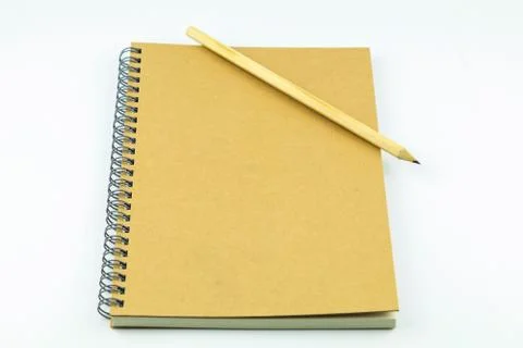 Close notebook with pencil on white background Stock Photos