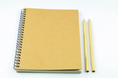 Close notebook with pencil on white background Stock Photos