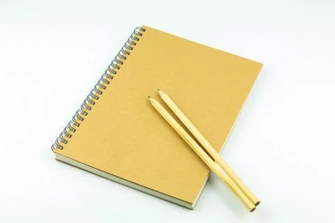 Close notebook with pencil on white background Stock Photos