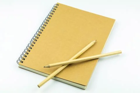 Close notebook with pencil on white background Stock Photos