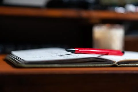 Close-up of Notebook with Red Pen and Candle Stock Photos