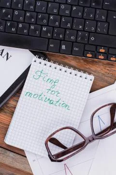 Close-up of notepad with words time for motivation, glasses and keyboard on Stock Photos