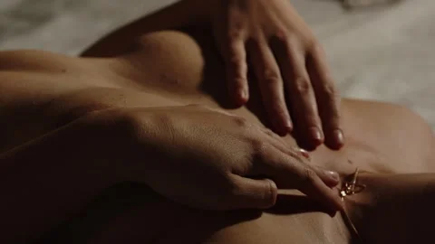 Close up of nude breasts being covered by hands Stock Footage 270732088