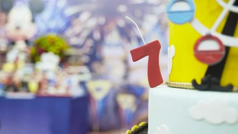 Close up of number 7 red candle on birthday cake Stock Footage 265446561