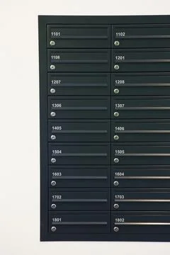 Close Up Of Numbered Mailboxes In Apartment Building Foto stock
