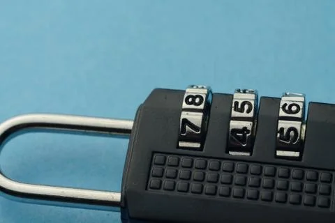 Close up numbered padlock over blue background. Stock Photos