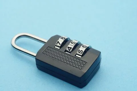 Close up numbered padlock over blue background. Stock Photos