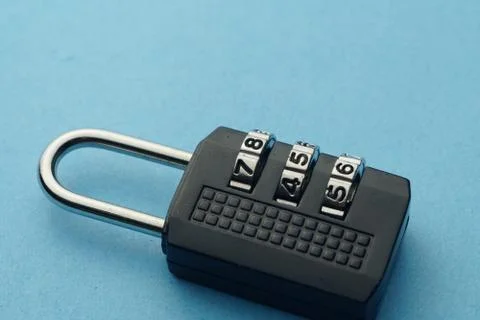 Close up numbered padlock over blue background. Stock Photos