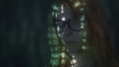 Close up of Numerical Script Scrolling Down Face of Woman in Glasses in studio Stock Footage 208782691