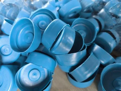 Close-up of Numerous Blue Plastic Bottle Caps Stacked Together Foto stock
