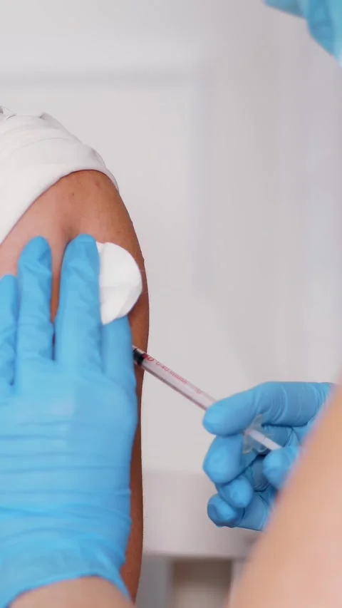 Close-up, nurse, in blue protective gloves, makes vaccination with vaccine Stock Footage 323439190