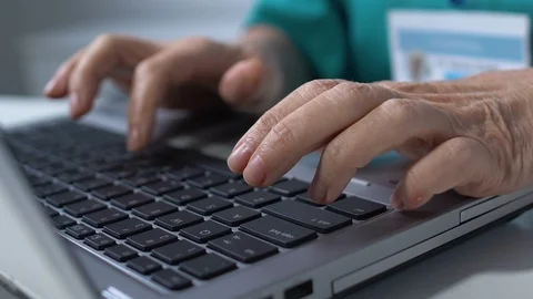 Close-up of nurse hands typing on laptop, filling data in medical record online Stock-Footage 118907192