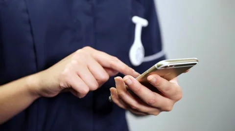 Close up nurse hands using mobile cell phone Stock Footage 59087345