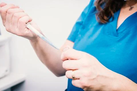 Close-up of a nurse taking samples with a canister Stock Photos