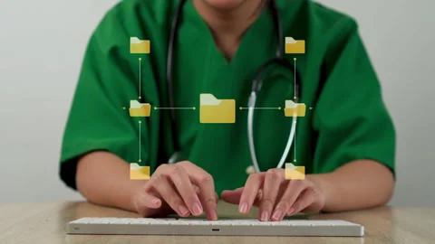Close-up of nurse typing on keyboard with floating central folder hierarchy and Stock Footage 347638559