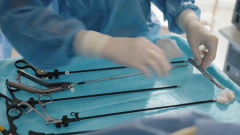 Close up of nurse's hand cleaning the table after surgery. The surgeon and the Stock Footage 173536931