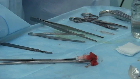 Close-up of a nurse's hand is served with clean scalpels and clamps and a tampon Stock-Footage 125816644