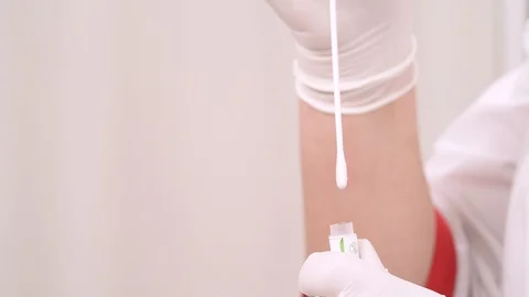 Close-up of nurses hands holding cotton swab and test tube after collecting Video stock 110269178