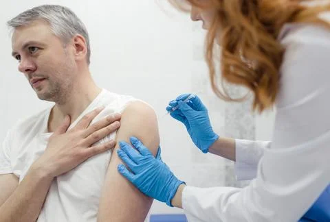 Close-up of the nurse's hands vaccinating patients with a syringe.The docto.. Stock Photos