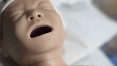 Close-Up of Nursing School Doll Used to Practice Baby Care Stock Footage 233761389