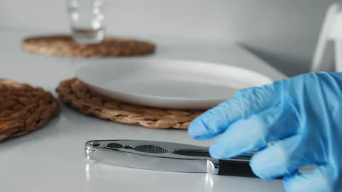 Close up nut cracker on the white table with two dish. Stock Footage 151993962