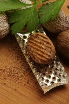 Close up on nutmeg on the grater Stock Photos