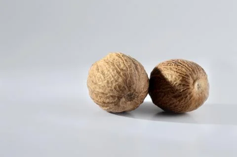 Close up of Nutmeg on a gray background Stock Photos