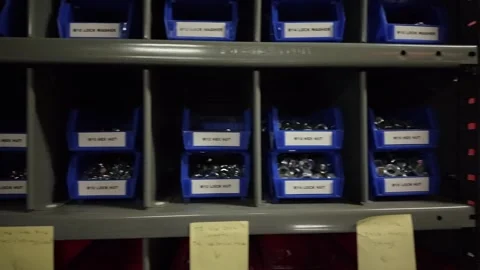 Close up of nuts and bolts in blue bins in industrial shop Stock Footage 341323623